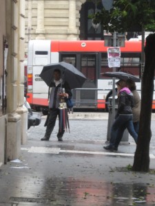 man_selling_umbrellas_rome_italy